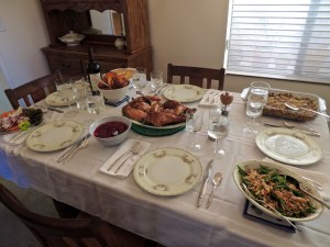 Relish tray, steamed green beans with canned onion rings on top, homemade cranberry sauce, turkey, dressing, baked yams, and a cornbread casserole.