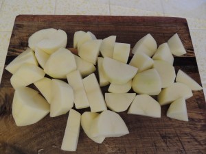 Peel and cut four potatoes and several carrots.