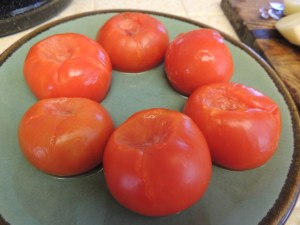 Thaw six frozen whole tomatoes on the "defrost fish" setting of the microwave. Cut in half and discard tough skins.