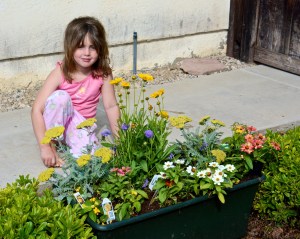 Our granddaughter Megan with her butterfly garden.