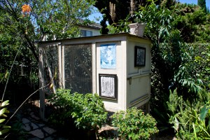 The chicken coop is to the left (south) of the herb garden. Fruit trees grow beyond.