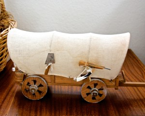 A little covered wagon, handmade in Mexico--this inexpensive E-bay find came with a tiny shovel, rifle, powder horn, barrel, and plow--everything a pioneer family might need.